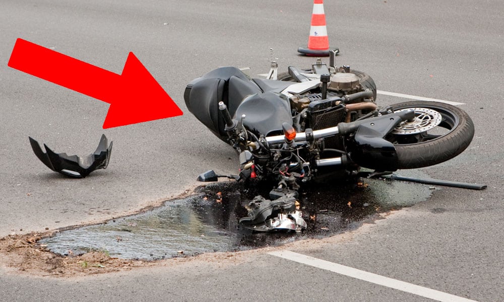 image of a motorcycle leaking fuel after a crash