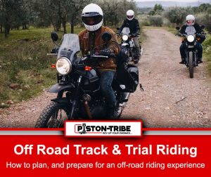 Three motorcyclists riding on a dirt track in an off-road setting, wearing helmets and protective gear. The lead rider, wearing a brown jacket and white helmet, is on a black motorcycle with a clear windshield, followed by two other riders on similar bikes in the background. The trail is surrounded by grassy terrain and trees. Below the image, a red banner reads: "Off-Road Track & Trail Riding - How To Plan And Prepare For An Off-road Riding Experience.