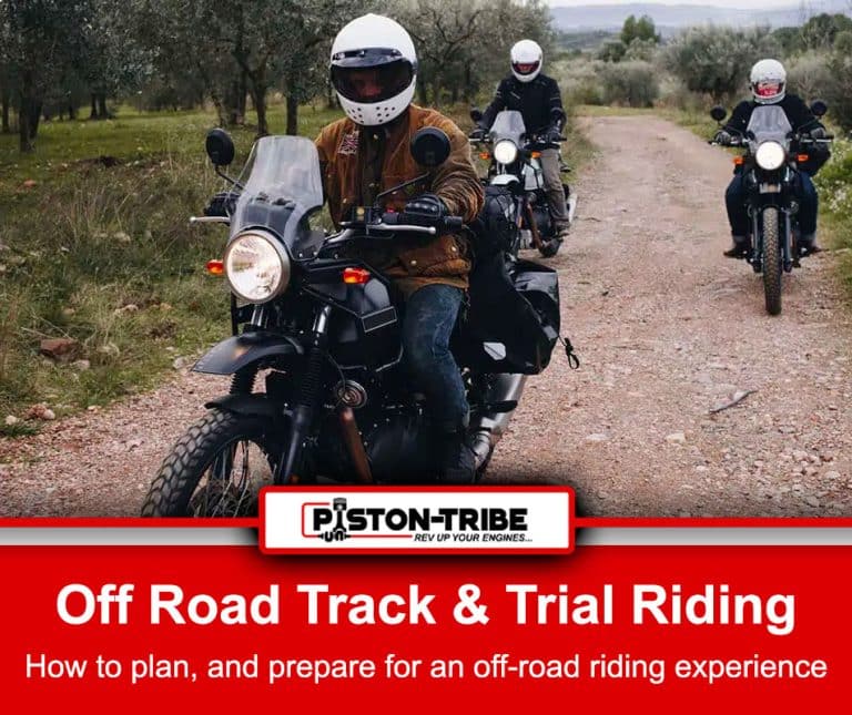 Three motorcyclists riding on a dirt track in an off-road setting, wearing helmets and protective gear. The lead rider, wearing a brown jacket and white helmet, is on a black motorcycle with a clear windshield, followed by two other riders on similar bikes in the background. The trail is surrounded by grassy terrain and trees. Below the image, a red banner reads: "Off-Road Track & Trail Riding - How To Plan And Prepare For An Off-road Riding Experience.