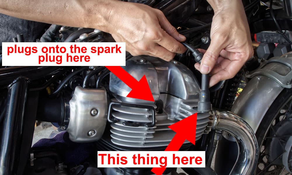 image of a spark plug cap and spark plug on a motorcycle engine