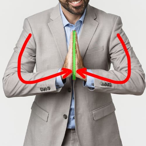 image of man forcing hands together in example of force