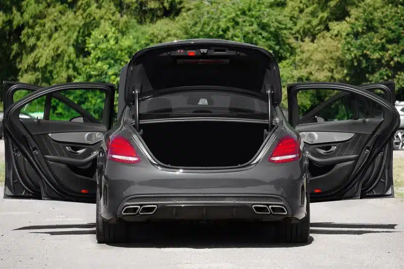 A luxury car with all doors and trunk open, showcasing elegant design and spacious interior.