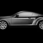 a side profile of a luxurious black coupe on a plain black b