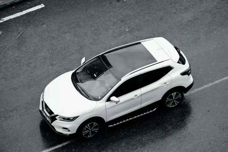 A white SUV is seen from above cruising along the wet streets of Istanbul, Turkey.