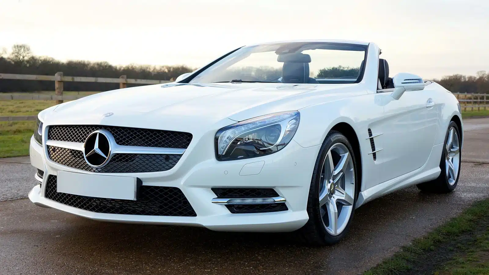 Elegant white Mercedes-Benz convertible on a scenic countryside road in the United Kingdom.