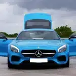 front view of a blue mercedes benz sports car with open door