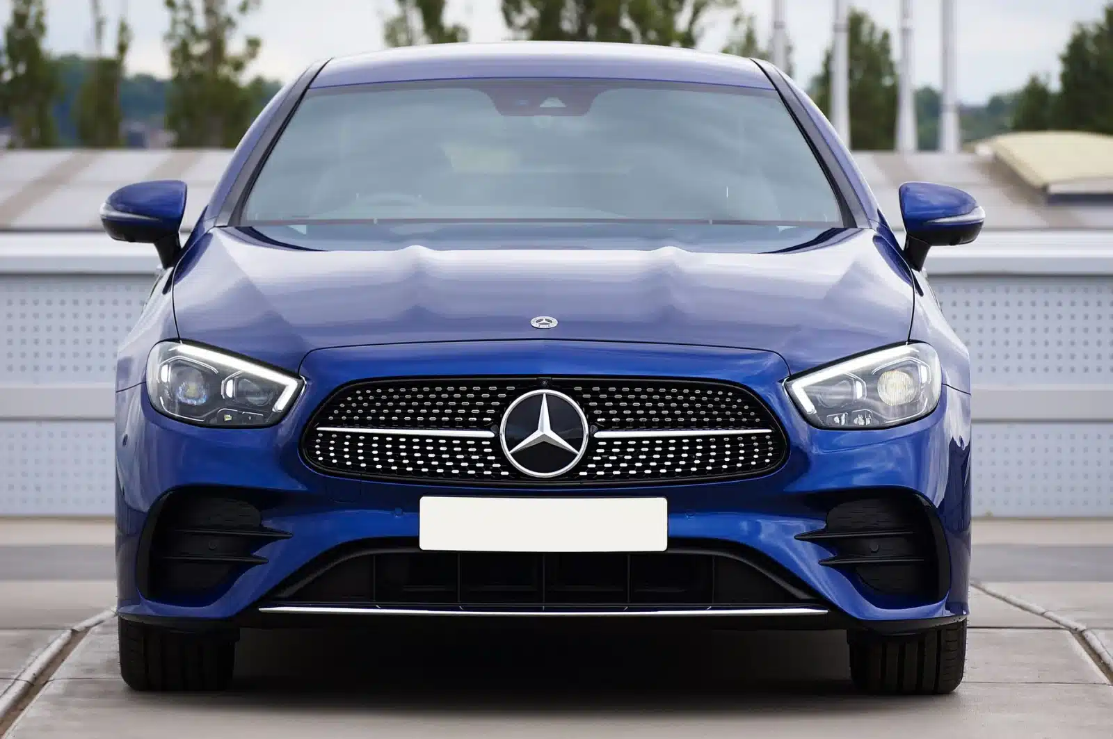Sleek front view of a blue luxury Mercedes-Benz sedan, showcasing elegance and design.