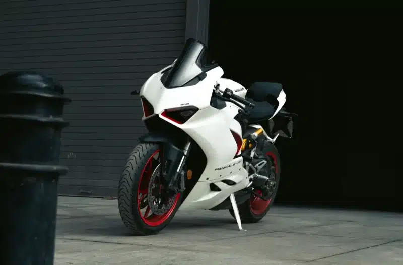 Close-up of a white Ducati motorbike parked outdoors in Bengaluru.