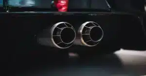 Close-up shot of dual exhaust pipes on a sleek car, with a focus on detail and design.
